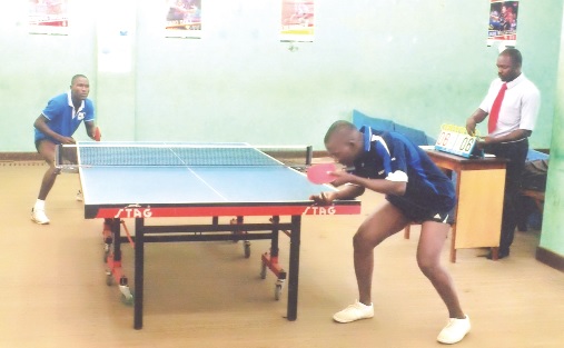 A  Togolese player serves as Ghana’s Emmanuel Commey (left) waits eagerly to revceive.