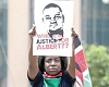 A woman holding a picture of Albert Ojwang, the Kenyan blogger who died while being held at a police station in Nairobi