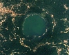 A more recent satellite photo, captured in 2024, shows that the level of gold mining around Lake Bosumtwe has increased significantly over the last decade. | Credit: NASA/Landsat