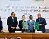 Representatives of the two countries exchanging the documents after the signing ceremony