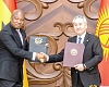 Samuel Okudzeto Ablakwa (left), Minister of Foreign Affairs, exchanging copies of signed agreements with Jeenbek Kulubayev, Foreign Minister of Kyrgyzstan