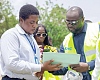 John Bawah (right) being shown some drawings at the Pokuase site