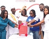 Grace Antwi Hayford (middle), The Mirror Model Mother, 2025, being assisted by Doreen Hammond (3rd from right), Editor, The Mirror; Regina Ofori (left), Head of Marketing and Brand, Ecobank Ghana PLC, and her family to cut the Mother’s Day cake. Picture: ELVIS NII NOI DOWUONA