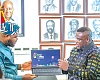 Samuel Nartey George (right),  Minister of Communication, Digital Technology and Innovations; and Mohammed Adams Sukparu, Deputy Minister of Communication, Digital Technology and Innovations, displaying one of the laptops