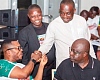 Dr Asmah (seated left) in a hearty chat with a loyal customer of Amenfiman Bank while Dr Toni Aubynn (seated right), Board Chairman, and Robert Asare, Head of Community Engagement, look on admirably