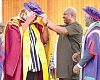 President Mahama decorating Ibrahim Mahama with a doctoral hat
