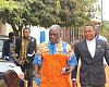 Ademan Tetteh (2nd from right), one of the directors of the Institute, being escorted by two security personnel