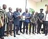 Dr Godwin Kafui Ayetor (in smock), Chairman of the Toyota Voxy Vehicles Investigative committee,  presenting a copy of the report to Abraham Amaliba, Director-General of the NRSA