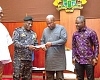 COP Christian Tetteh Yohuno (2nd from left), IGP, presenting the cheque to President John Mahama. With them are Muntaka Mohammed Mubarak (left), Minister for the Interior, and Kwabena Mintah Akandoh, Minister of Health
