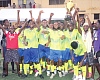 Players and supporters of Community 2 Sakasaka celebrating with the winner's trophy