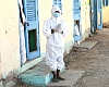 • A health worker wearing a protective outfit at a hospital where cholera patients are treated in Sudan