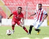 Kotoko’s Daniel Adjetey gains control of the ball ahead of Emmanuel Gyamfi of Legon Cities during their game yesterday. Picture: EMMANUEL BAAH