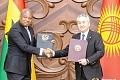 Samuel Okudzeto Ablakwa (left), Minister of Foreign Affairs, exchanging copies of signed agreements with Jeenbek Kulubayev, Foreign Minister of Kyrgyzstan