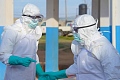 Medical staff must wear protective equipment when treating people with Ebola because it spread through bodily fluids