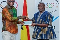 Richard Akpokavie (right), GOC President presenting the cheque to Kofi Iddi Adams, Sports Minister