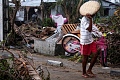 A man walks with his belongings after Cyclone Gezani tore through the port city of Toamasina, on the island of Madagascar, leaving a trail of destruction, February 12, 2026. REUTERS/Stringer