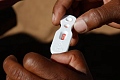 A Zambian healthcare worker checks a malaria test in this file photo in Matongo village, April 23, 2008. REUTERS/Thierry Roge (ZAMBIA)/File Photo