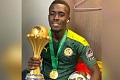 Idrissa Gueye with the AFCON trophy