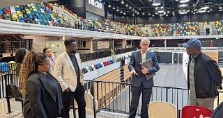 Kofi Adams (right), Minister of Sports and Recreation, being briefed by a facility management expert during an official tour of key sporting facilities in the UK