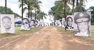 Photographs of murdered former officials displayed along a highway in Monrovia