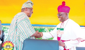 Most Rev. Francis Bomansaan (right), the Bishop of the Diocese, congratulating Alban Bagbin on his exceptional statesmanship