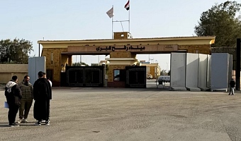 People stand near the Rafah border crossing between Egypt and the Gaza Strip, in Rafah, Egypt, January 27, 2026. REUTERS/Stringer