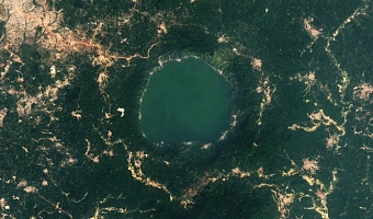 A more recent satellite photo, captured in 2024, shows that the level of gold mining around Lake Bosumtwi has increased significantly over the last decade. | Credit: NASA/Landsat