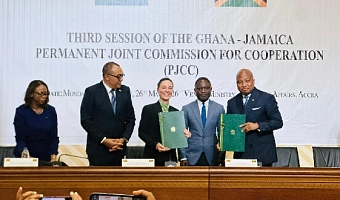 Representatives of the two countries exchanging the documents after the signing ceremony