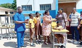 Ebi Bright (2nd from right), MCE for Tema, handing over the furniture to Bernice Ofori, Tema Metropolitan Director of Education