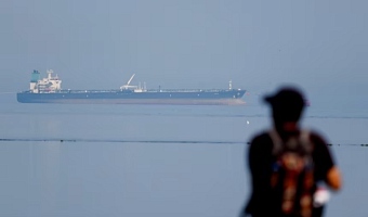 A tourist watches the MT Desert Kite oil tanker carrying Russian oil at Narara Marine National Park in the Arabian Sea, Gujarat, India, on March 11, 2026. Amit Dave/Reuters