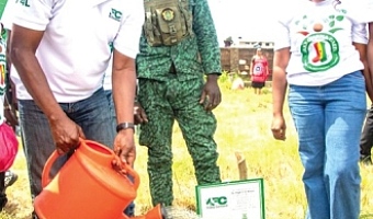 Dr Hugh C.A Brown (left), Chief Executive of the Forestry Commission, planting a tree to mark World Environment Day