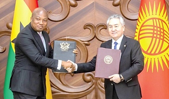 Samuel Okudzeto Ablakwa (left), Minister of Foreign Affairs, exchanging copies of signed agreements with Jeenbek Kulubayev, Foreign Minister of Kyrgyzstan