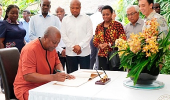 President John Mahama signing a visitors' book at the National Orchid Garden in Singapore