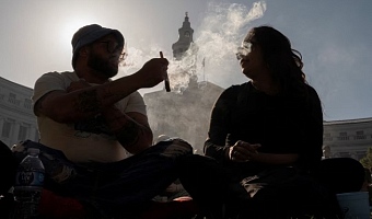 Revellers smoke cannabis at the Mile High 420 Festival in Denver, Colorado, U.S., April 20, 2026. REUTERS/Cheney Orr