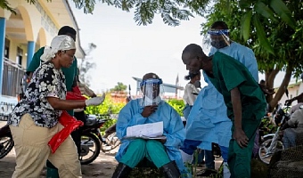 A health worker shows his colleagues a list of patients at Rwampara Hospital in Ituri, in the eastern Democratic Republic of the Congo