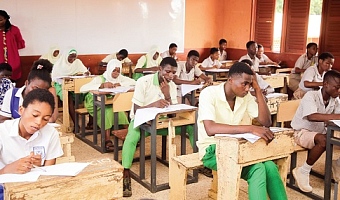 Candidates writing their Basic Education Certificate Examination at the Kanda Cluster of Schools in Accra with invigilators overseeing the session. Picture: CALEB VANDERPUYE