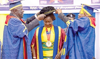 Sir Sam Jonah (left), Chancellor of UCC, and Justice William Atuguba, Chairman of the UCC Governing Council, robing Prof. Naana Jane Opoku-Agyemang at the ceremony