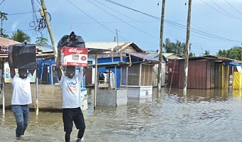 Some flood victims carrying their salvaged items to safety. Picture: DOUGLAS ANANE-FRIMPONG