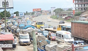 Tricycles compete with vehicles from the Kasoa-Accra section at Mangoline. Pictures: DOUGLAS ANANE-FRIMPONG & ERNEST KODZI