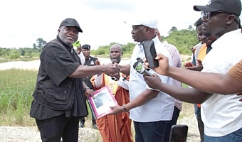 Emmanuel Armah-Kofi Buah (right), Minister of Lands and Natural Resources, handing over the project site to Nana Kyeame Ampratwum, Lead Operational Director, RM Ecorestore