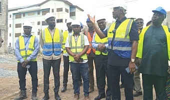 Courage Nunekpeku (2nd from right) explaining the extent to which work has been carried out during the tour of the Kpone Affordable Housing Project site at Community 26.