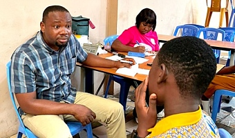 Dr Godwin Asamoah  Ahiakwao Principal Optometrist, Ga North Municipal Hospital, attending to a student at the screening