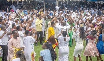 A section of a congregation dancing during praises