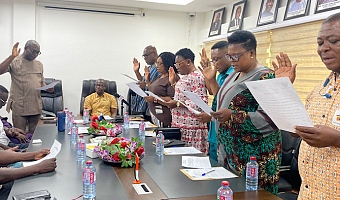 Mr Thomas Thompson-Aryee (left), Acting Director-General of the Internal Audit Agency, swearing in members of the newly inaugurated audit committee of the National Food Buffer Stock Company (NAFCO) 