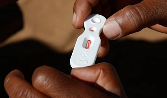A Zambian healthcare worker checks a malaria test in this file photo in Matongo village, April 23, 2008. REUTERS/Thierry Roge (ZAMBIA)/File Photo