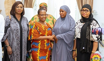 Comfort Doyoe Cudjoe (left), First Deputy Majority Whip, presenting the cash amount to a member of the late MP’s family 
