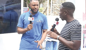 Kweku Zurek (right), Assistant Editor, Graphic Online, speaking to a representative from Eden Heights