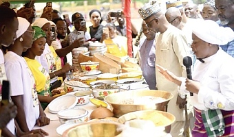 Failatu Abdul-Razak (right), the main chef at the event, showing the various dishes to patrons