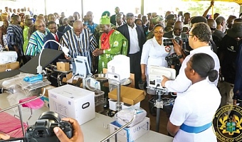 Prof. Samuel Kaba Akoriyea (arrowed), Director-General of the Ghana Health Service, explaining to President John Dramani Mahama (in smock) and other government officials some uses of various health equipment during the exhibition