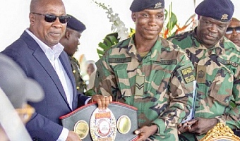 Jerry Lartey presenting his WBA International Super Lightweight title to President John Mahama (left) during the recent WASSA event at Burma Camp, Accra